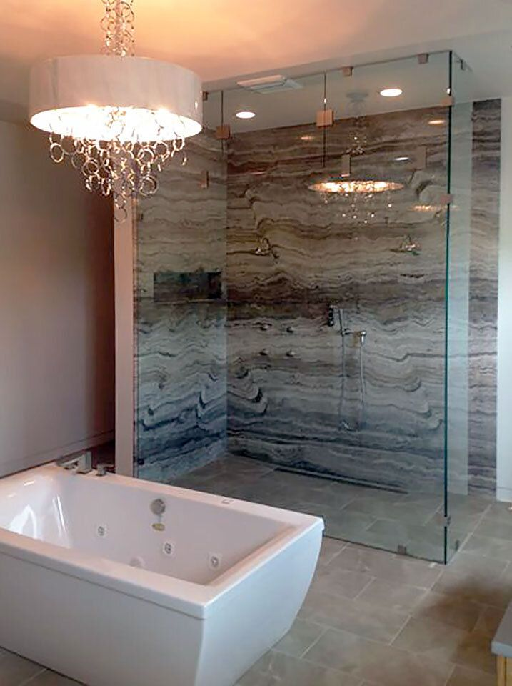 A frameless shower door next to a bathtub creating a spa-like vibe