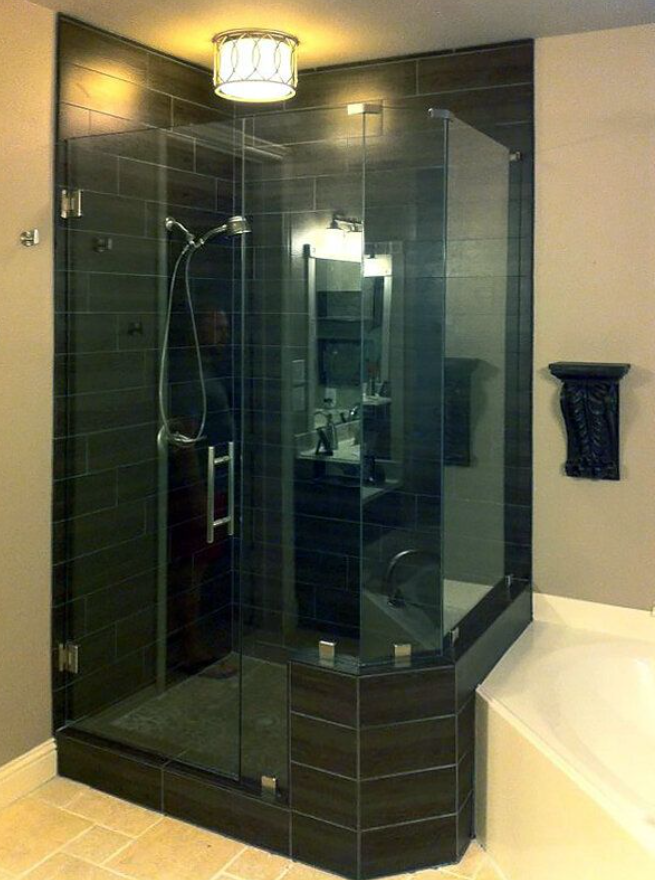 A corner shower with a clear glass shower door in Austin