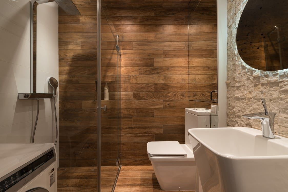 a bathroom with a wooden wall